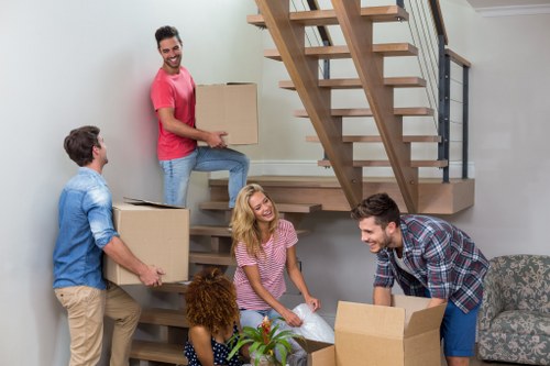Professional flat removals team handling boxes in Twickenham