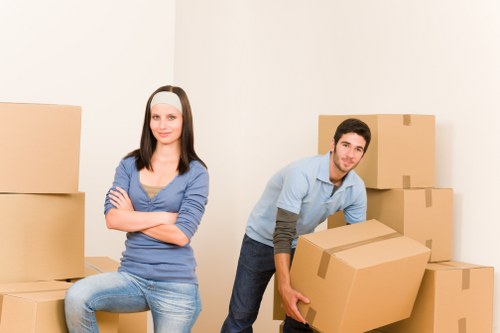 Twickenham moving team organizing office equipment and packed boxes