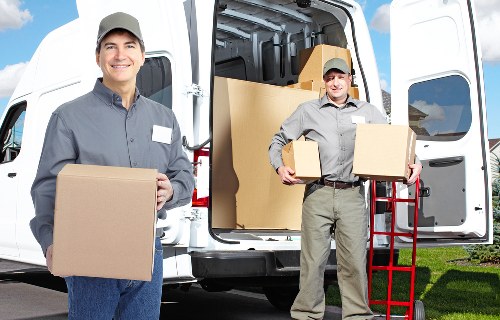 Safe and insured movers in Twickenham carrying furniture carefully