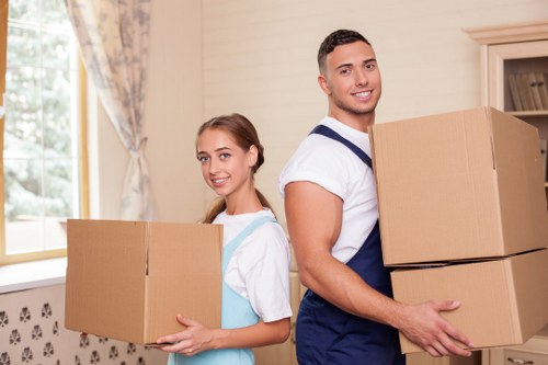 Removal team using safe lifting techniques with furniture